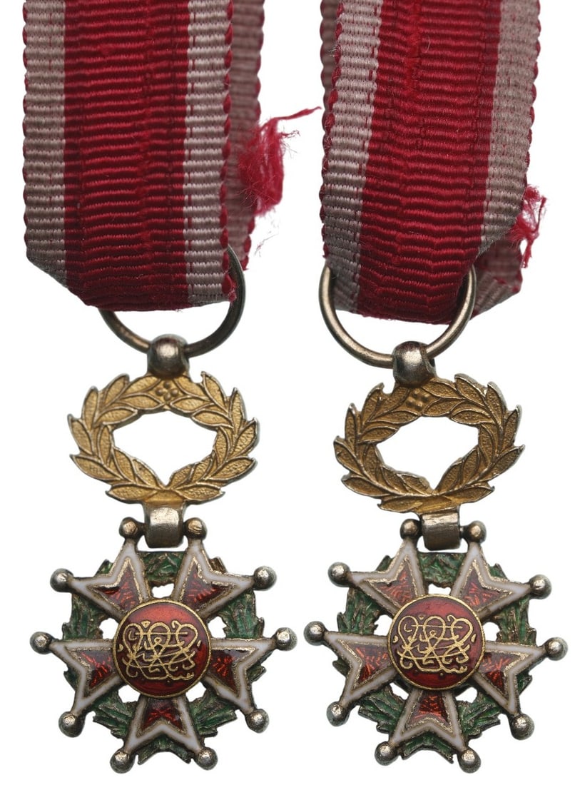 Order of the Brilliant Star of Zanzibar: Knight's Cross Miniature, instituted in 1963. Breast Badge, 20x12 mm., gilt Silver, enameled, original suspension wreath and ribbon. A beautiful, rare miniature, in extremely fine condition! I R!"