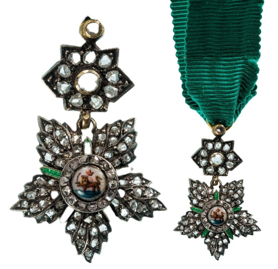 Order of the Sun and the Lion: A jewelled miniature of the Order: five-pointed star in Silver, profusely set with Diamonds, flanked by five green enameled blade-shaped rays; centre medallion with miniature-enameled image of the lio