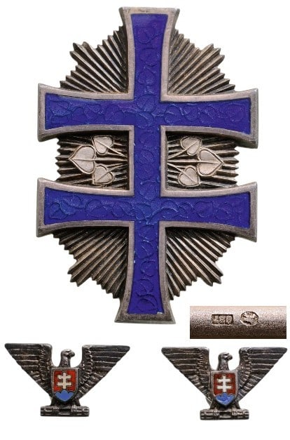 Order of the War Victory Cross: A Third Class Badge in Silver with blue enameled double cross (lime leaves visible through the translucent enamel), sided by two groups of three lime leaves each and resting on a star of thin, polishe