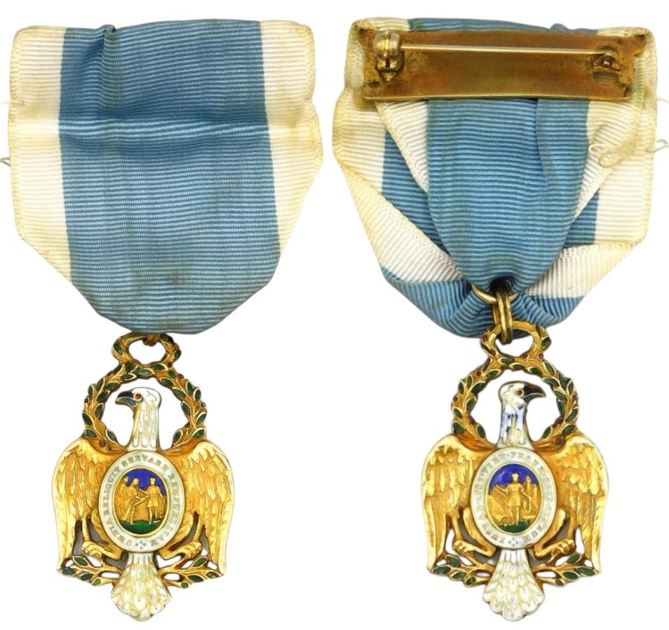 The Cincinnati Eagle: The Bailey Banks and Biddle eagle. Finely chased Gold in the form of an American eagle facing left with wings spread and down swept. Its head is in a circular laurel wreath highlighted with green leav