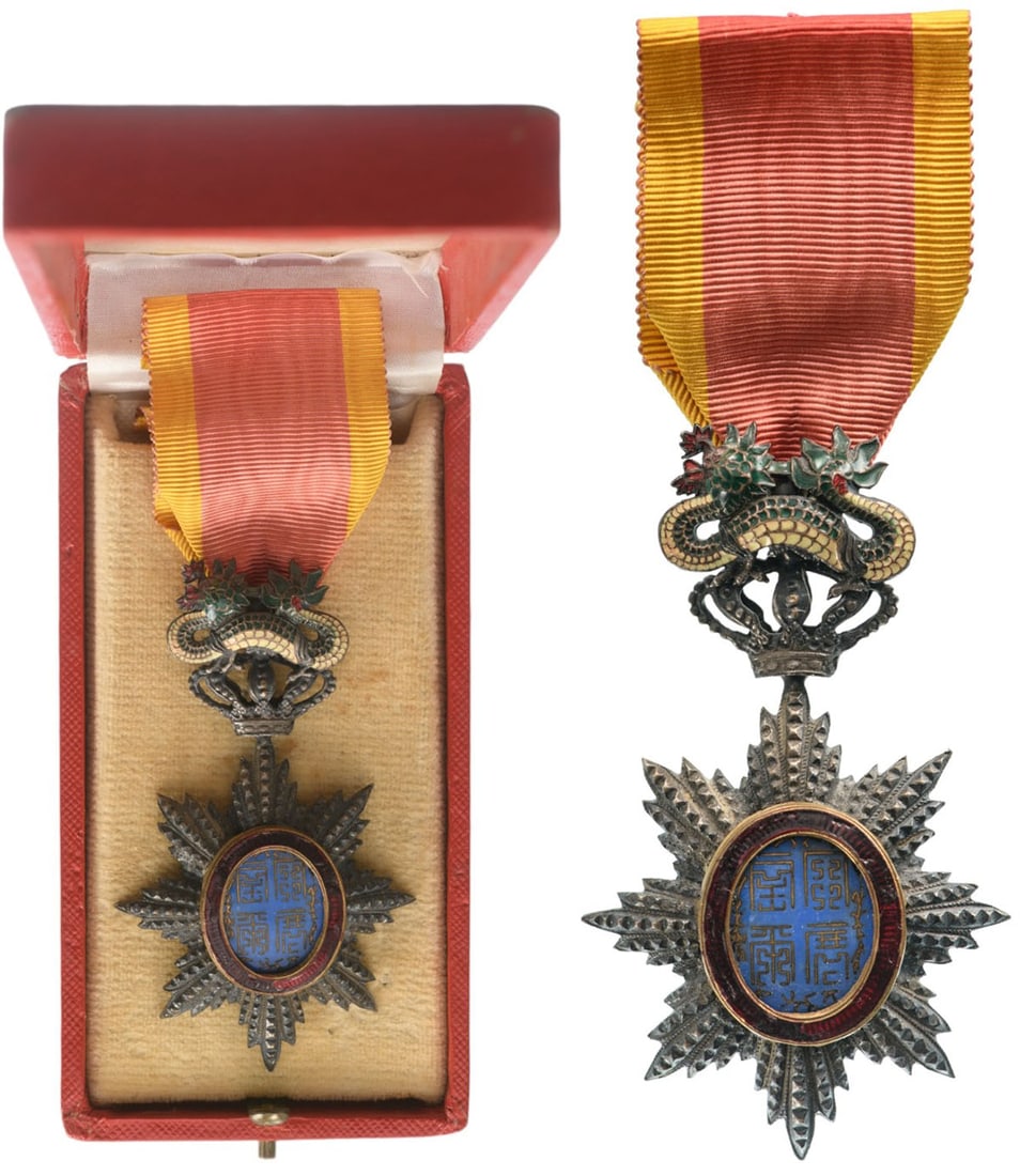 ORDER OF THE DRAGON OF ANNAM: Knight's Cross, 5th Class, instituted in 1886. Breast Badge, 83x49 mm., Silver, brilliant cut rays, central medallion enameled, original suspension device, ring and ribbon, in case of issue. A very fi