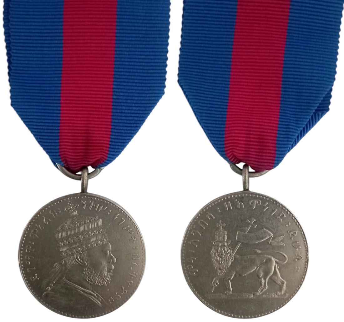 Menelik II Silver Medal, 1899: Breast Badge, 38x31 mm, Silver, original suspension ring and ribbon. Extremely fine and attractive! I