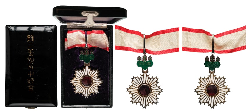 ORDER OF THE RISING SUN (Kyokujitsusho): Commander`s Cross, 3rd Class. Neck Badge, 87x55 mm, Silver, both sides enameled, original suspension device and ribbon, in original laquered case of issue, with gilt inscription on the lid. I