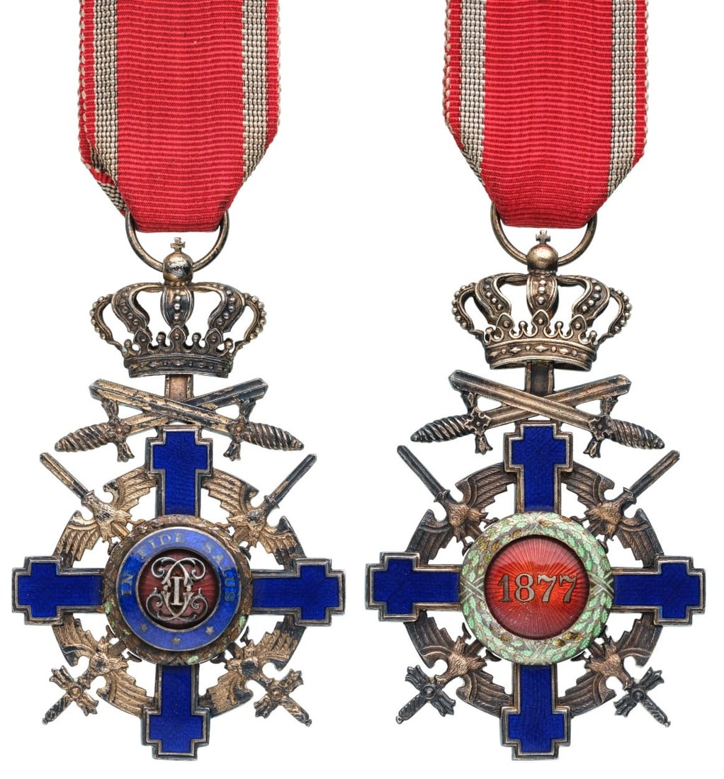 ORDER OF THE STAR OF ROMANIA, 1864: Knight`s Cross, 2nd Model (1940), for Foreign Officer`s in Time of War. Breast Badge, 66x42 mm., Silver, enameled, with original suspension ring and ribbon. Obverse medallion with cipher of Carol I, r