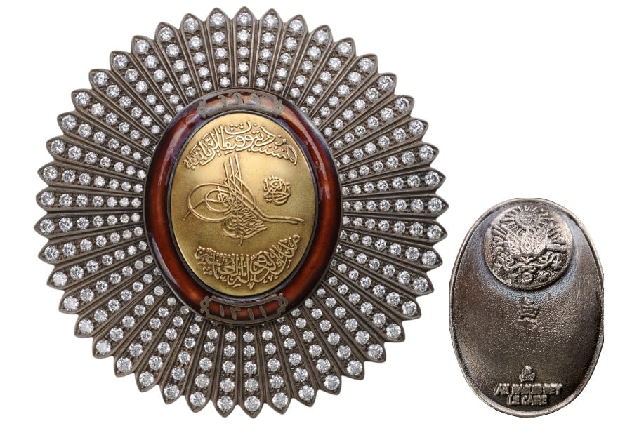The Unique, Jeweled Breast Star of the Order of the Ottoman Dynasty, belonged to Prince Sehzade: Silver Star of slightly oval form, 84 mm., with dagger-shaped rays, all profusely set with brilliants, centre medallion in gold embossed with the Sultanâ??s Mahmud II (1784â??1839) Tughra and inscri