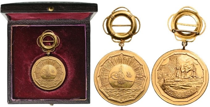 Medal for the Support to the Ottoman Fleet (Donanma ?ane Madalyas?): Small, GOLD Merit Medal, 28 mm., the obverse, with the Sultan’s Tughra, on a large beaming sun rising from the sea, the reverse, with a dreadnought-type warship at full-steam with the landscape of C