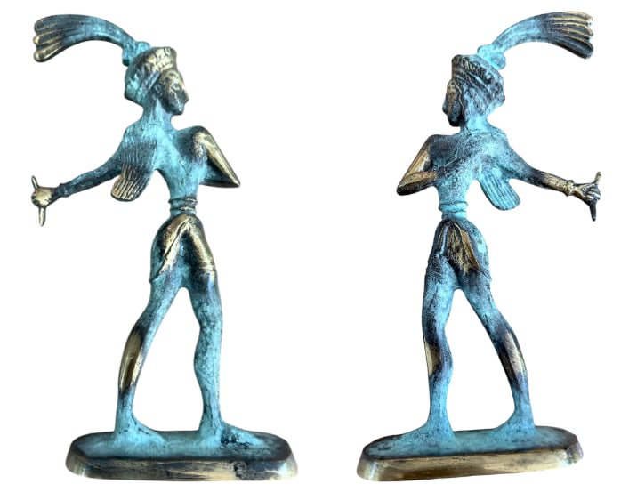 Bronze Statuette depicting a Dancer: A double-plated bronze statuette depicting a dancer with a plumed headdress, based on an archaic model (a maenad?...). The long-haired dancer, standing on an oval base, holds a krotala (?) in her