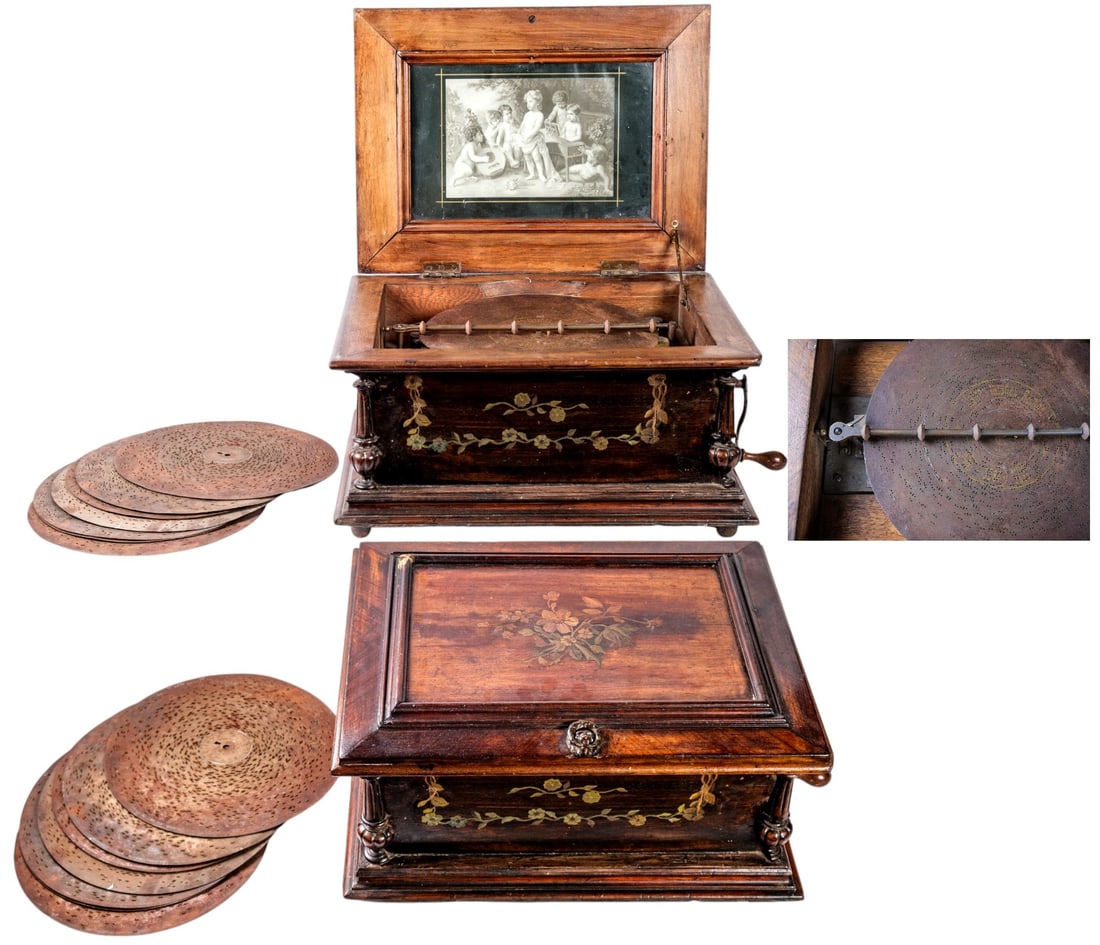 Large Symphonion: Large functionning Symphonion metal disc music box, Paul Lauchemann process, crank winding, walnut veneer body, wooden chest decorated with a marquetry frieze in floral inlays, lithographed interior c