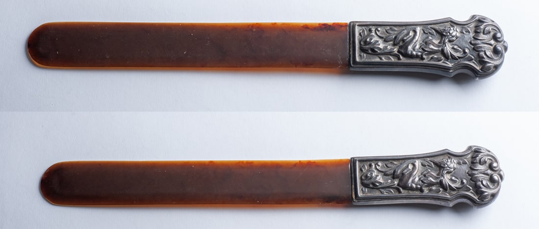 Large desk decorative element: Large desk decorative element paper-cut type, consisting of a large amber blade and a silver handle embossed with a relief about a satyr. Good condition, slight fragility at the junction. Gross weight
