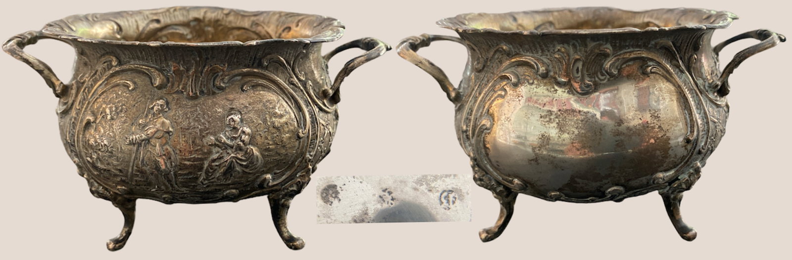 Silver cookie jar: Silver cookie jar, quadripod model with two handles, rounded body carved with a mute cartouche decorated with volutes, "marquise-marquise" genre scene, flowered sides. Hallmarks to be identified,
