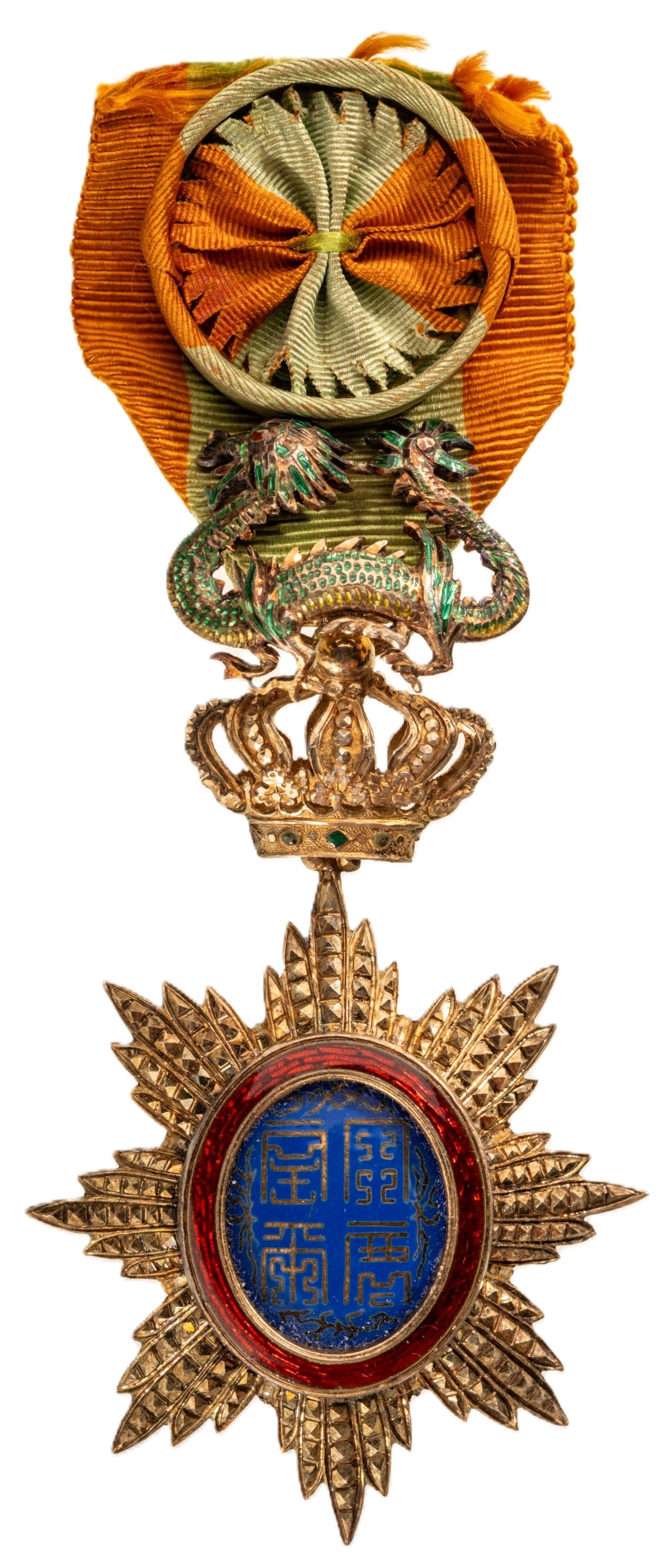 ORDER OF THE DRAGON OF ANNAM: Officer's Cross, 4th Class, instituted in 1886. Breast Badge, 87x48 mm., gilt Silver, brilliant cut rays, central medallion enameled, original suspension device, ring and ribbon with rosette. An extre