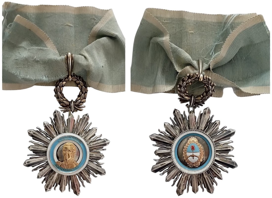 Order of the Libertador San Martin: Commander`s Cross, 3rd Class, institued in 1943. Neck Badge, 64x88 mm, partially gilt Silver, central medallion gilt, enameled, original suspension wreath, loop and neck ribbon. Scarce and very attrac