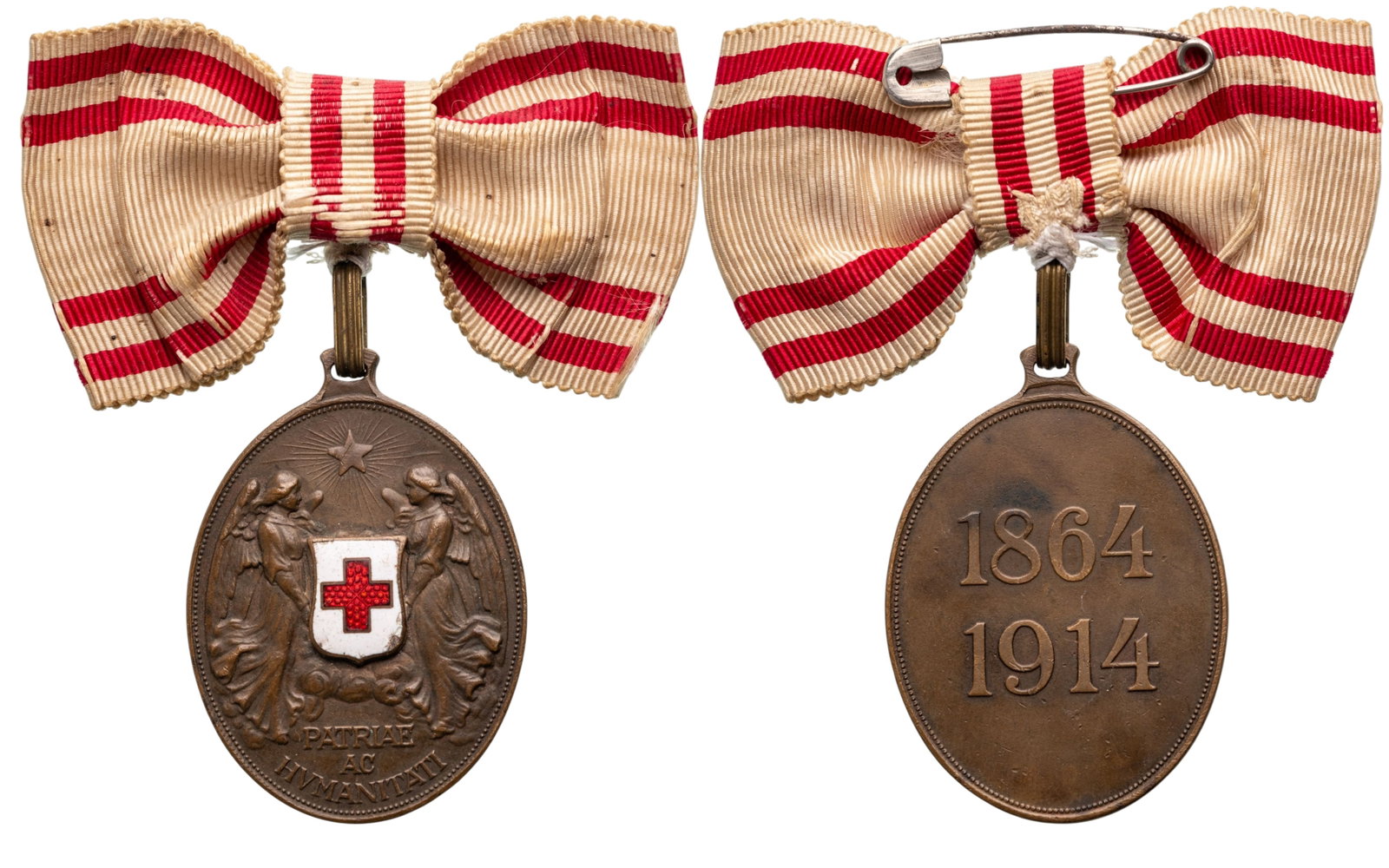 Red Cross Merit Medal: Bronze Class, instituted in 1864. Breast Badge, 49x35 mm., Bronze, original suspension ring and ladies ribbon with bow. Extremely fine! I
