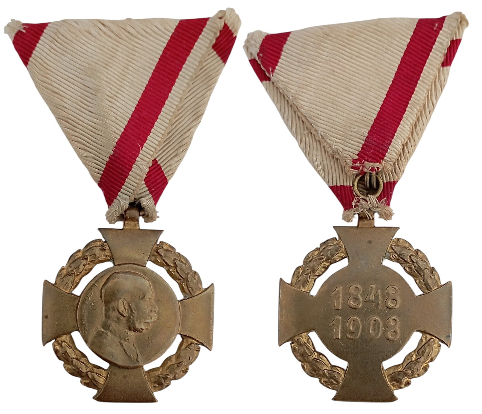 Commemorative Cross 1848 - 1908: Breast Badge, 43x37 mm., gilt Bronze, original suspension ring and triangular ribbon. Extremely fine condition! I
