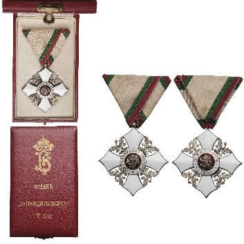 Order for Civil Merit: Knight's Cross, 5th Class, 2nd Pattern, 1910. Breast Badge, 54x51 mm, silvered, central medallion enameled, original suspension ring and triangular ribbon, in case of issue, with gilt monogram of Tsar