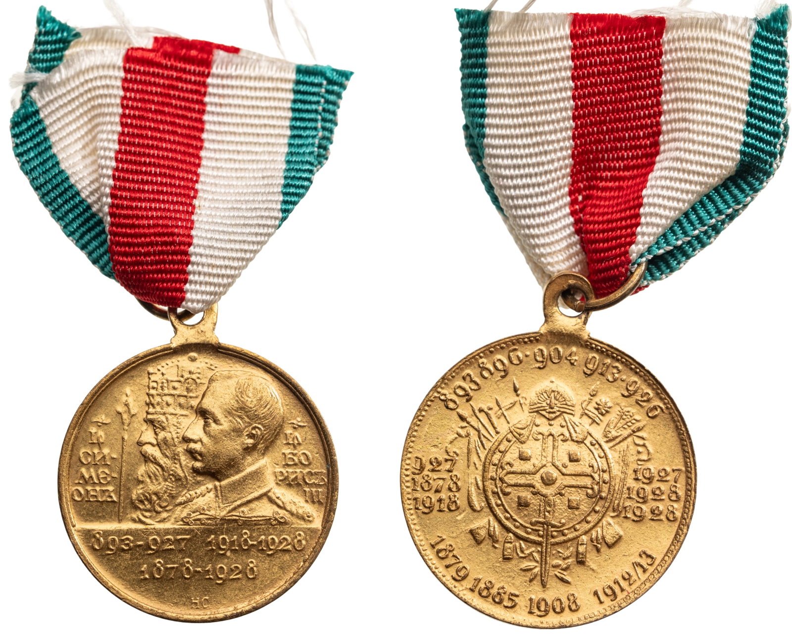 Commemorative Medal for the 10th Anniversary of Reign of King Boris III 1918-1928) and Tsar Simeon I: Breast Badge, 37x32 mm., gilt Bronze, original suspension ring and triangular ribbon, in original damaged enveloppe of issue. Mint condition!