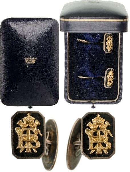 Pair of Cufflinks: Black enameled octagons, bearing the crowned, 17x12 mm, Gold monogram â??TBâ?? with crossed shovel and pickaxe beneath, the reverse, fitted with a prong and a spring-folding oval counter-button with