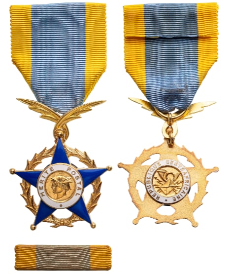 The Order of Postal Merit: Knight's Cross, instituted in 1962. Breast Badge, 65x42 mm., gilt Bronze, original suspension device,ring and ribbon, together with bar. Very attractive and mint conditionI Scarce! I R!