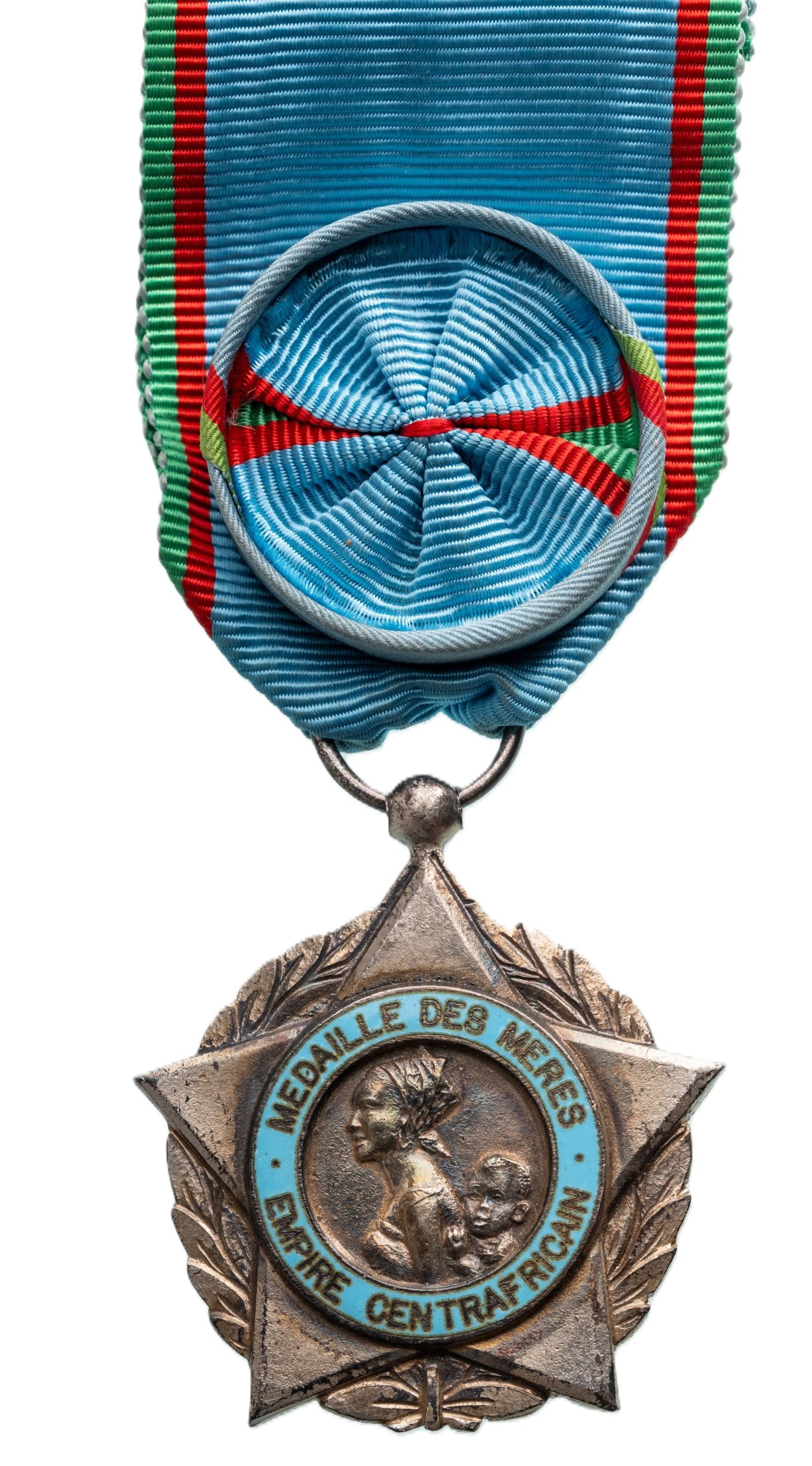 Medal of Honour for the Mothers: 2nd Class, for 10 Children, instituted in 1966. Breast Badge, 51x46 mm., silvered, one side enameled, original suspension ring and ribbon with rosette. Mint state! I