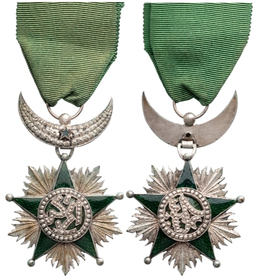 Order of the Star of Grand Comoros (SAID ALI): Knight's Cross, 5th Class. instituted in 1910. Breast Badge, 68x43 mm., Silver, enameled, original suspension crescent, ring and ribbon. Very fine! I