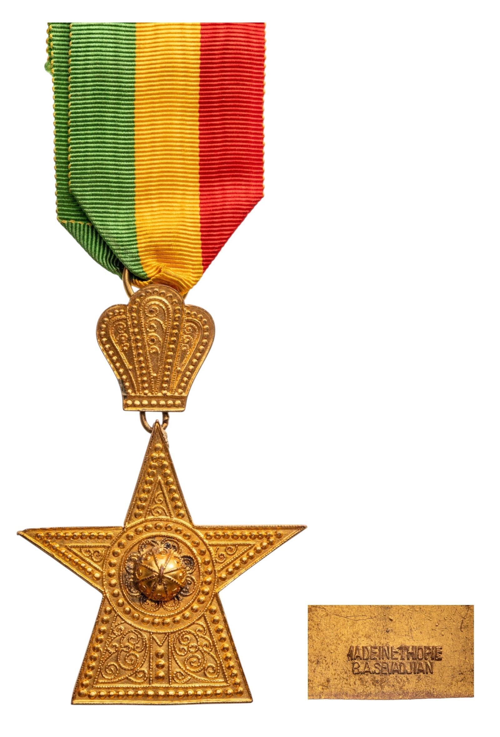 Imperial Order of the Star of Ethiopia: Knight's Cross, instituted in 1884. Breast Badge, 77x55 mm., gilt Bronze, maker's mark "B.A. Sevadijan - Ethiopia", original suspension ring and ribbon.Excellent condition! I