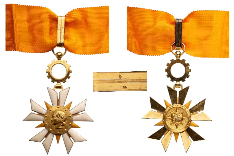 NATIONAL ECONOMY ORDER: Commander`s Cross, 4th Republic, 1st Class, instituted in 1954. Neck Badge, 80x55 mm., gilt Silver, hallmarked, one side enameled, original suspension wheel, loop and complete ribbon. Extremely fine