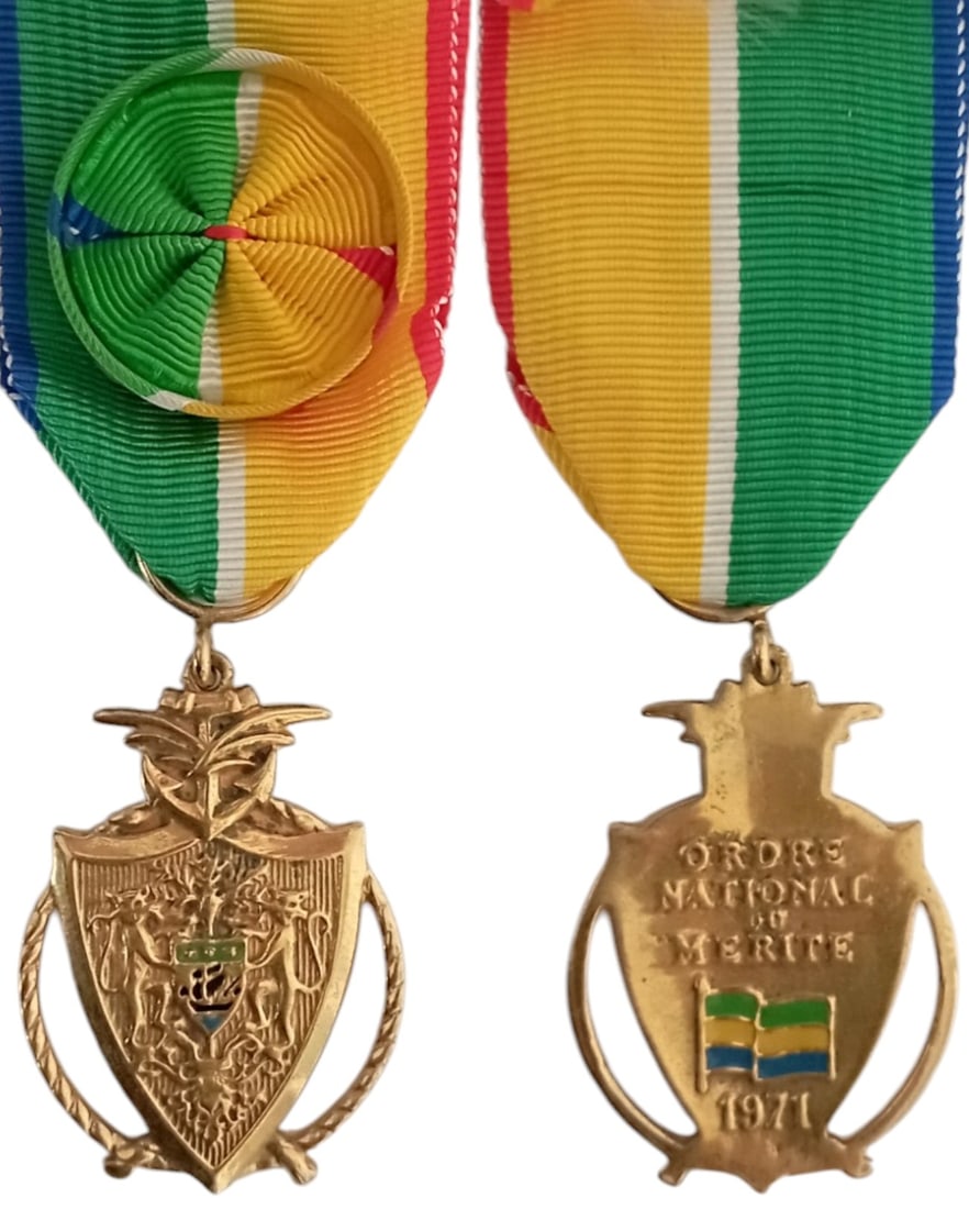 NATIONAL ORDER OF MERIT: Officer's Cross, instituted in 1971. Breast Badge, gilt Bronze, 47x30 mm, both sides enameled, original suspension ring and ribbon with rosette. Extremely fine! I