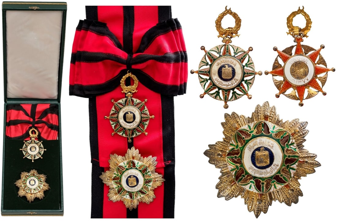 ORDER OF EL-RAFIDAIN (ORDER OF THE TWO RIVERS): Grand Cross Set, 2nd Model, instituted in 1922. Sash Badge, 96x67 mm, GOLD and Silver, as a red enameled star, enriched by a pattern of green/white enameled, stylized palms and lotus flowers; blue ena