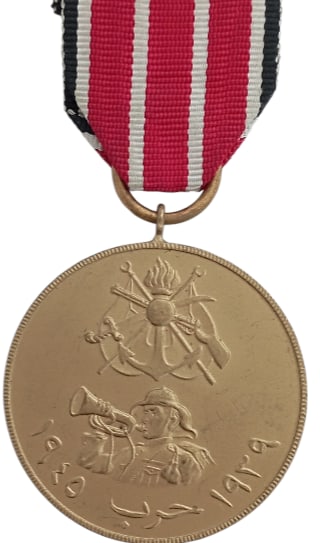 War Medal (Nut Al-Harb), 1939-1945: Breast Badge, 45x40 mm, gilt Bronze, original suspension ring and ribbon. Very attractive and mint condition! I