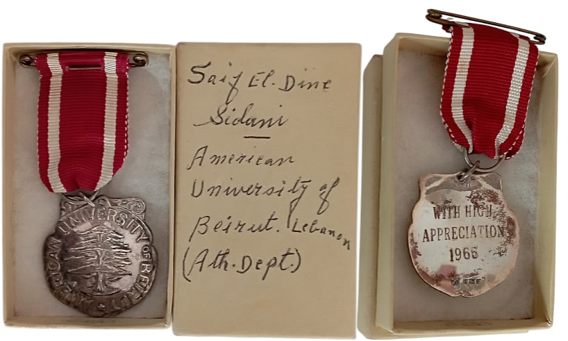 American University of Lebanon Medal: Breast Badge, 36x32 mm, Silver, hallmarked, dated 1966, original suspension ring and ribbon, in annoted case of issue to Saif El Dine Sidani. Scarce! I R!