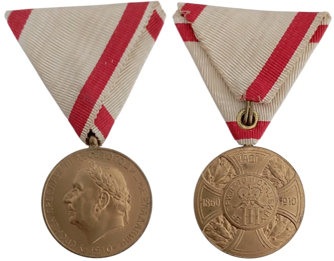 Commemorative Medal for the 50th Anniversary of reign of Prince Nicolas I, 1910, by Stefan Schwartz: Breast Badge, 38x34 mm, gilt Bronze, original suspension ring and triangular ribbon. Mint condition I
