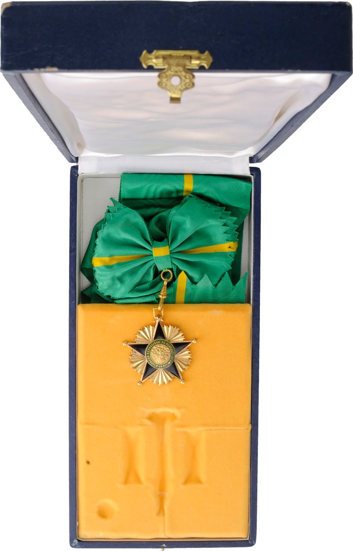 ORDER OF MERIT: Grand Cross Badge, instituted in 1960. Sash Badge, 63x58 mm, gilt Bronze, both sides enameled, original suspension device and long complete sash, in case of issue. A rare badge in perfect condition! I