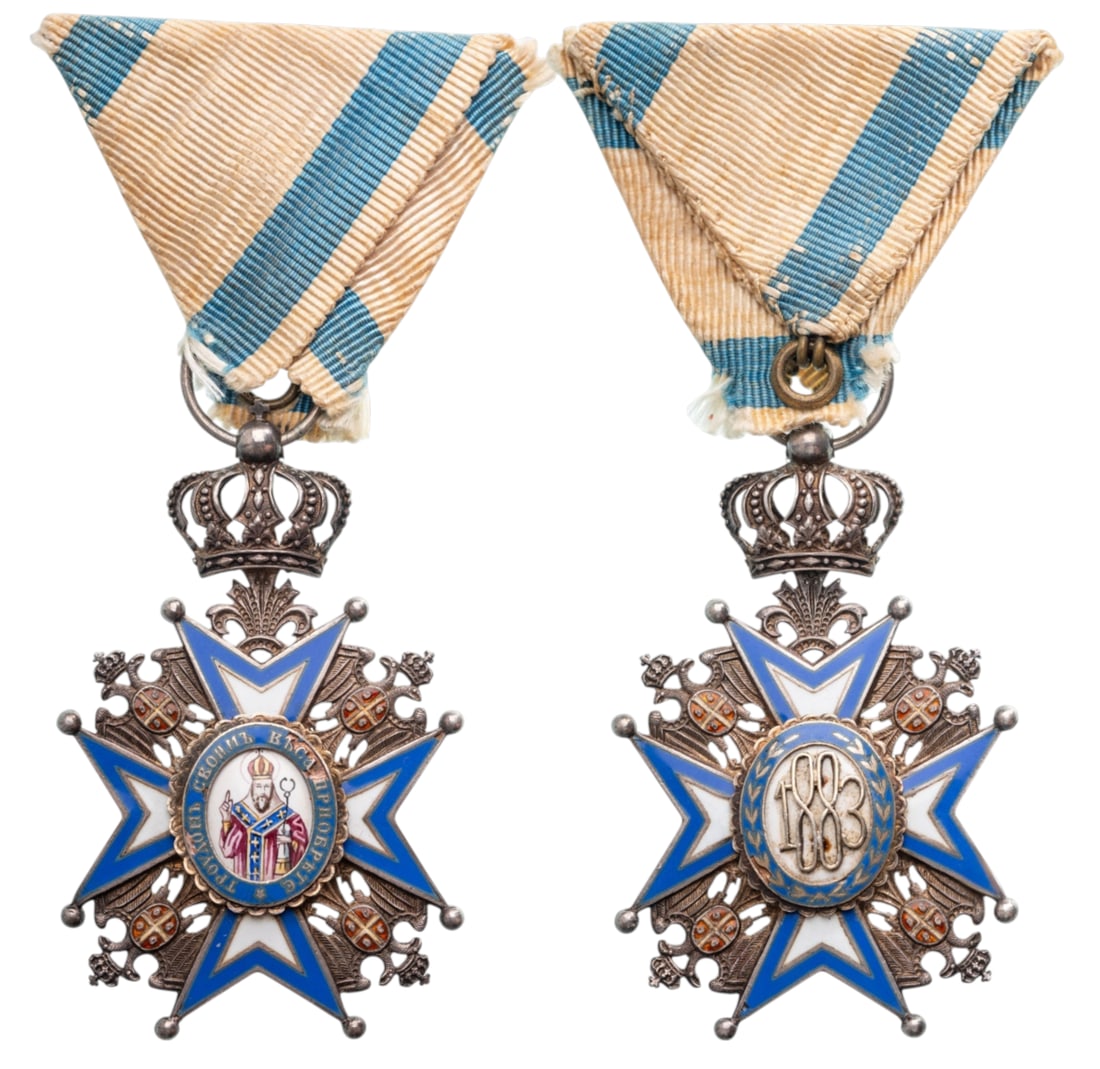 ORDER OF SAINT SAVA: Knight's Cross, 2nd Model, 5th Class, instituted in 1883. Breast Badge, 62x39 mm, Silver, enameled, original suspension with crown, ring and triangular ribbon. A superb old badge, in extremely fine