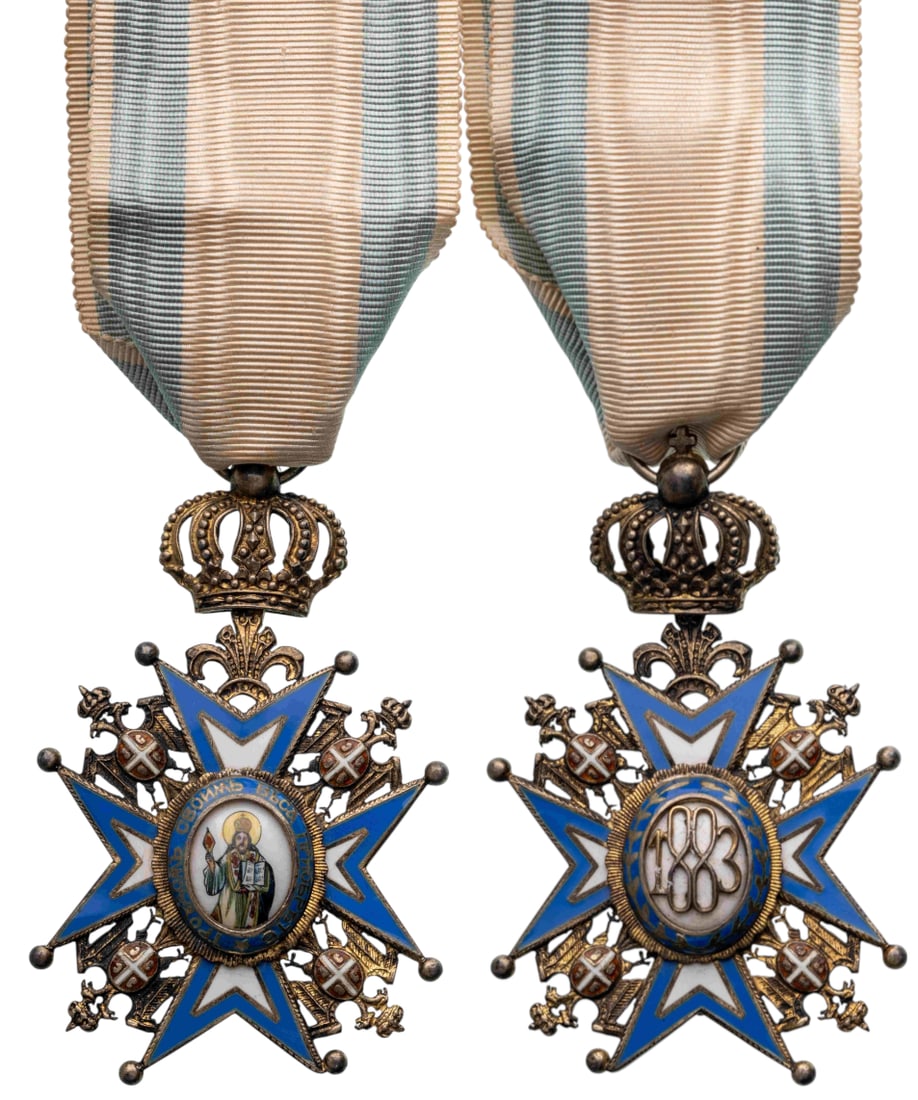ORDER OF SAINT SAVA: Officer's Cross, 3rd Model, 4th Class, instituted in 1883. Breast Badge, 68x41 mm, gilt Silver, enameled, original suspension with crown, ring and ribbon, one point bent. Very fine condition! II