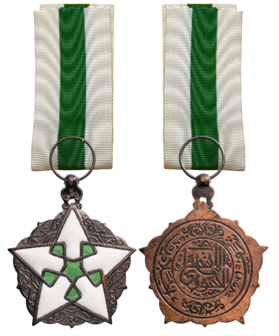 Order of Civil Merit: Knight's Cross, 5th Class, instituted in 1953. Breast Badge, 51x43 mm, silvered Bronze, Arabic maker's mark, one-side enameled, five-pointed, green and white enameled star, surrounded by wreath, origi