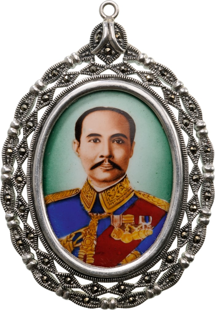 Honour Badge with the Royal portrait of Rama V: Silver, 44 mm., oval enamel miniature image of King Chulalongkorn (Rama V) in uniform, wearing orders and medals enclosed in an open-work Silver frame with chiseled and engraved ornamentation, the rev