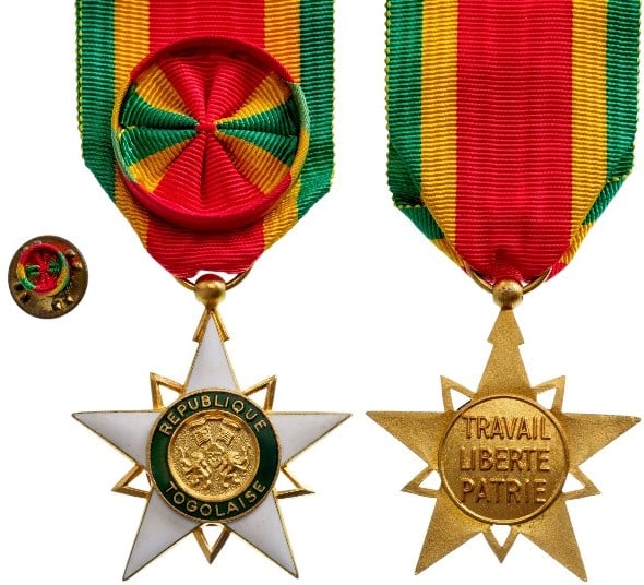 Order of Mono: Officer's Cross, instituted in 1961. Breast Badge, 38 mm, gilt Bronze, enameled, original suspension ring and ribbon with rosette and lapel hole rosette.A superb badge, in mint condition!I