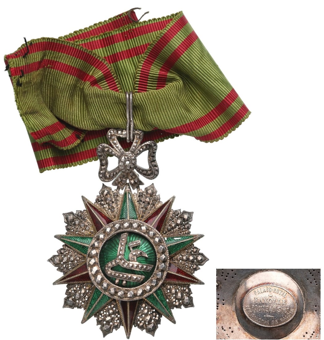 ORDER OF NICHAN AL IFTIKHAR: Commander's Cross, 3rd Class, Ali Bey (1882 - 1902). Neck Badge, 65x50 mm, Silver, maker's mark "Fayolle-Pouteau - Paris", partially enameled, original suspension loop and ribbon. A beautiful and rare