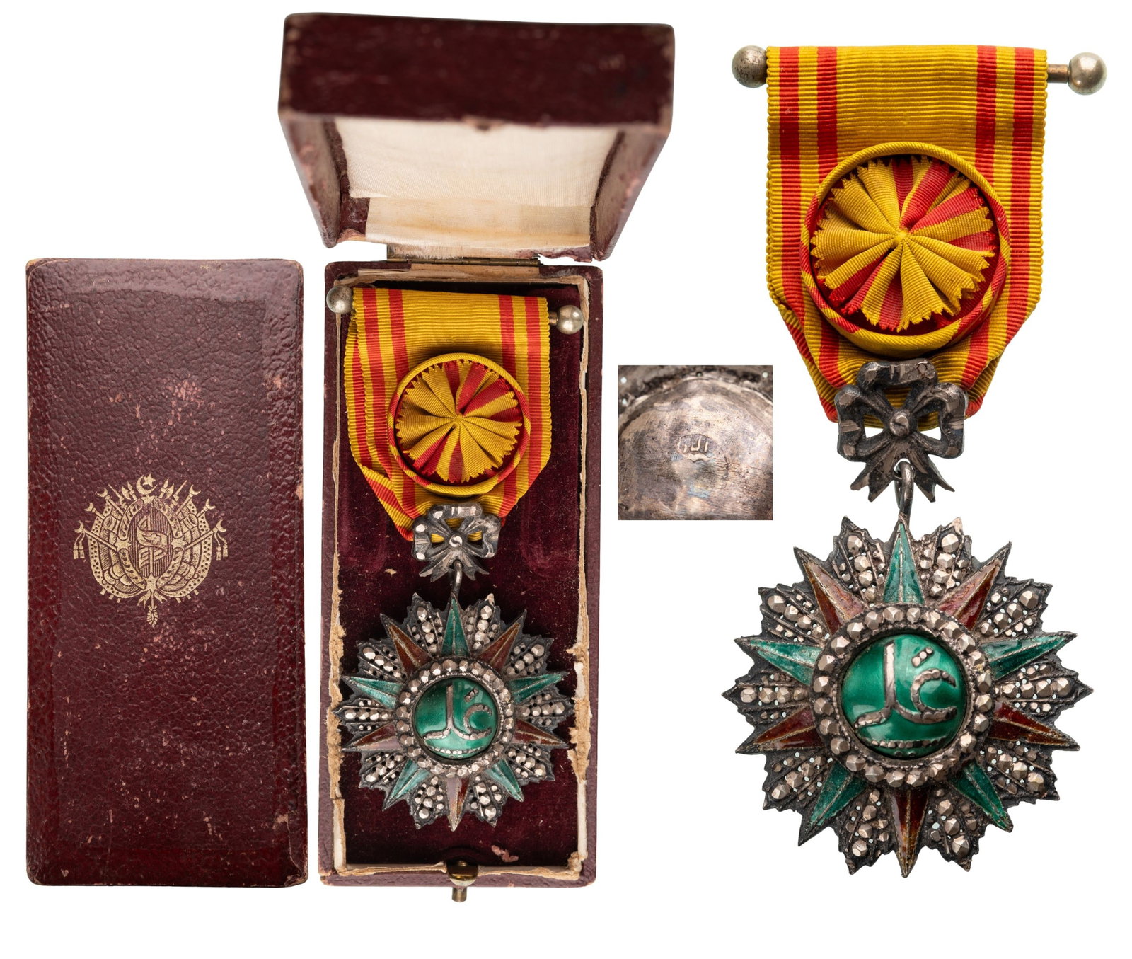 ORDER OF NICHAN AL IFTIKHAR: Officer's Cross, 4th Class, Ali Bey (1882 - 1902). Breast Badge, 65x44 mm, Silver, partially enameled, original suspension ring, loop and ribbon with bar and rosette, in case of issue with gilt weapon