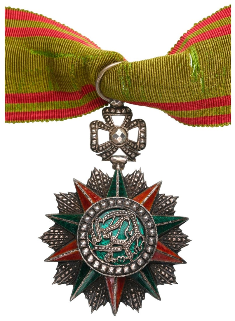 ORDER OF NICHAN AL IFTIKHAR: Commander's Cross, 3rd Class, Mohamed el Naceur (1905Ã¢Â?Â?1922). Neck Badge, 72x49 mm, Silver, one side enameled, original suspension ring and neck ribbon. A superb high jeweller's quality badge,