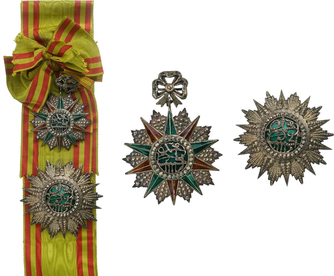 ORDER OF NICHAN AL IFTIKHAR: Grand Cross Set, 1st Class, Mohamed el Habib Bey (1922-1929). Sash Badge, 83x61 mm., Silver with brilliant cut rays, obverse enameled, original suspension device and long complete sash for Ladies. Bre