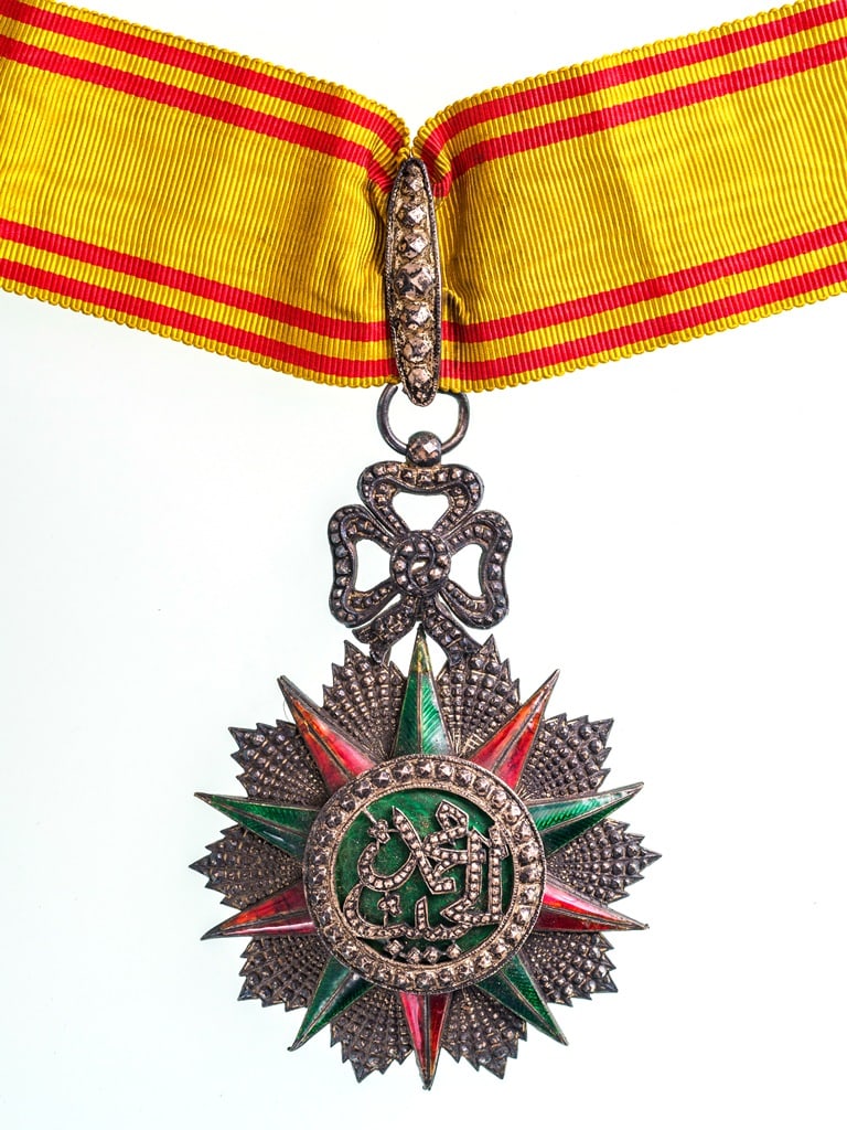 ORDER OF NICHAN AL IFTIKHAR: Commander's Cross, 3rd Class, Muhammad al Habib (1922-1929. Neck Badge, 83x60 mm, Silver, one side enameled, original suspension ring and neck ribbon. A superb high French quality! II R!