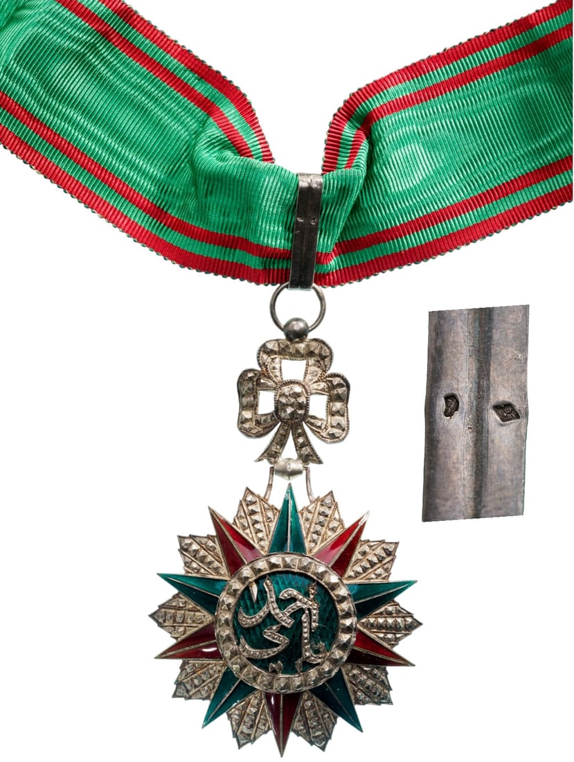 ORDER OF NICHAN AL IFTIKHAR: Commander's Cross, 3rd Class, Sidi Ahmed (1929 - 1942). Neck Badge, 82x57 mm, Silver, partially enameled, original suspension ring, loop and ribbon. A beautiful luxury fabrication, extremely fine cond
