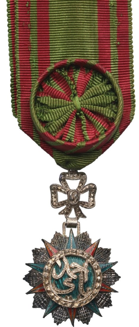 ORDER OF NICHAN AL IFTIKHAR: Officer's Cross, 4th Class, Sidi Ahmed (1929 - 1942).Breast Badge, 52x31 mm, Silver, partially enameled, original suspension ring, loop and ribbon. A very rare reduced size, of beautiful luxury fabric