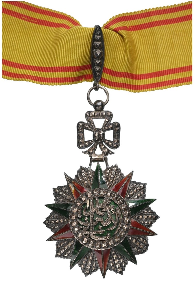 ORDER OF NICHAN AL IFTIKHAR: Commander's Cross, 3rd Class, Mohahmed el Amin (1943 - 1957). Neck Badge, 78x50 mm, Silver, enameled, original suspension ring, loop and ribbon. A beautiful luxury fabrication, extremely fine conditio