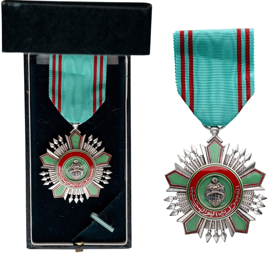ORDER OF THE REPUBLIC: Knight's Cross, 5th Class, instituted in 1963. Breast Badge, 56x48 mm., Silver, one-side enameled, original suspension ring and ribbon, in case of issue by "Arthus-Bertrand - Paris" with lapel bar, to