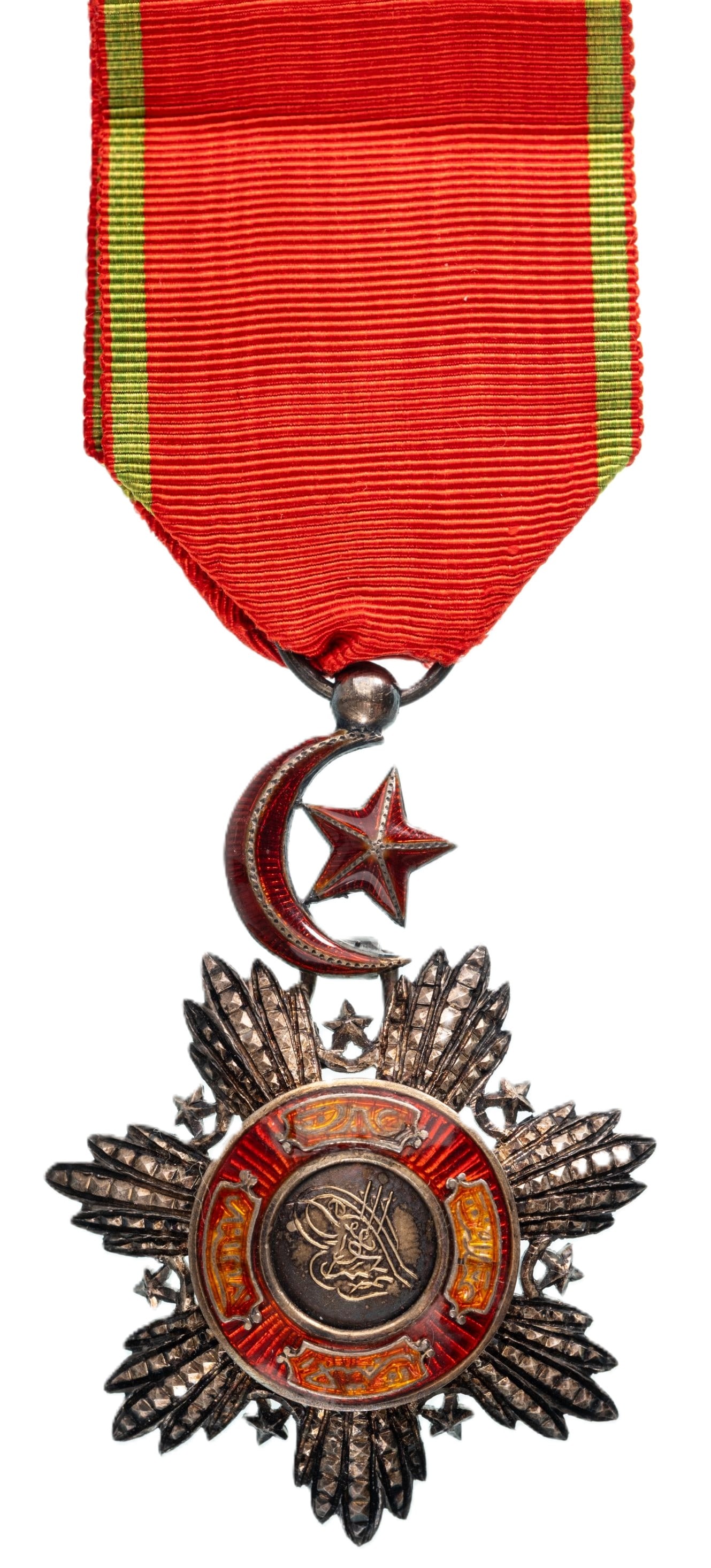 Order of Mecidi: Knights Cross, 5th Class. Breast Badge, 60x42 mm., Silver, enameled, chiseled and pierced silver with gold centre medallion also with the Sultan`s Tughra, with red enameled details and applied scrolls