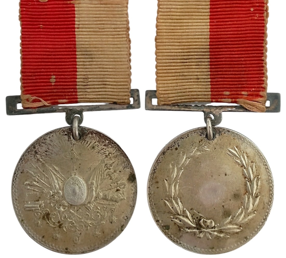 Industry Honor Medal (Osmanli Sanayi Iftihar Madalyasi), 1884: Breast Badge, 34x32 mm, Silver, original suspension device, ring and ribbon. Extremely fine condition. I.