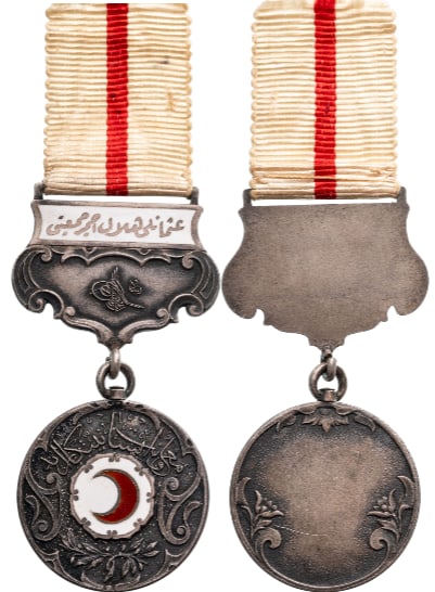 Red Crescent Medal (Hilel I Ahmer Madalyasi): 2nd Class, instituted in 1912. Breast Badge, 58x28 mm, Silver, original suspension enameled device, ring and ribbon. Extremely fine condition. I.