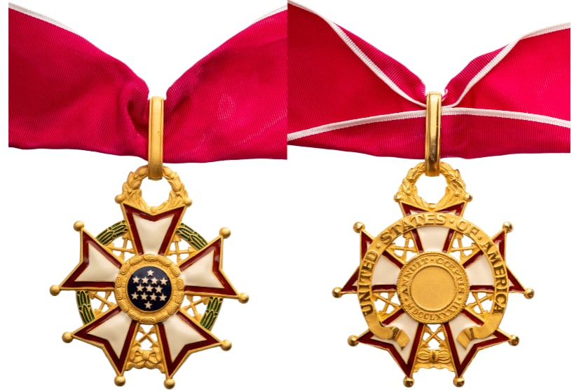 Legion of Merit, Commander, instituted in 1942: Neck Badge, 65x58 mm., gilt Bronze, one side enameled, on a wreath of green laurel joined at the bottom by a gold bow-knot (rosette), a five-pointed white star bordered crimson, points reversed with v